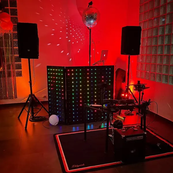 Cabina de DJ con luces rojas y bola de espejos en una casa